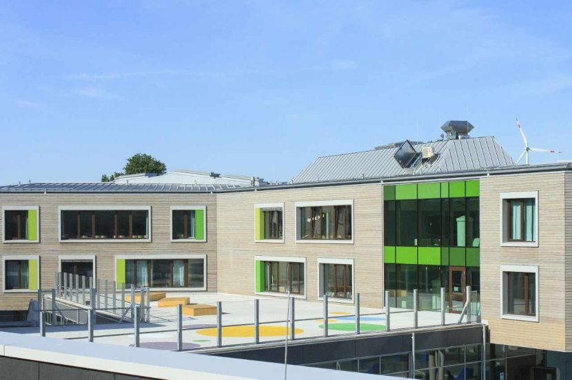 photo of a school with green windows